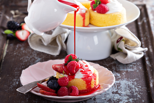 Pouring sauce onto fruit pudding