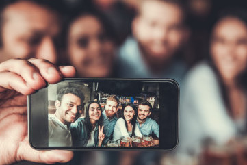 Group selfie in a bar.