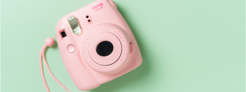 pink polaroid camera flat lay