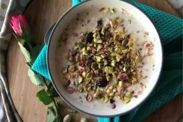 Porridge pistachios and cardomon seeds in a bowl