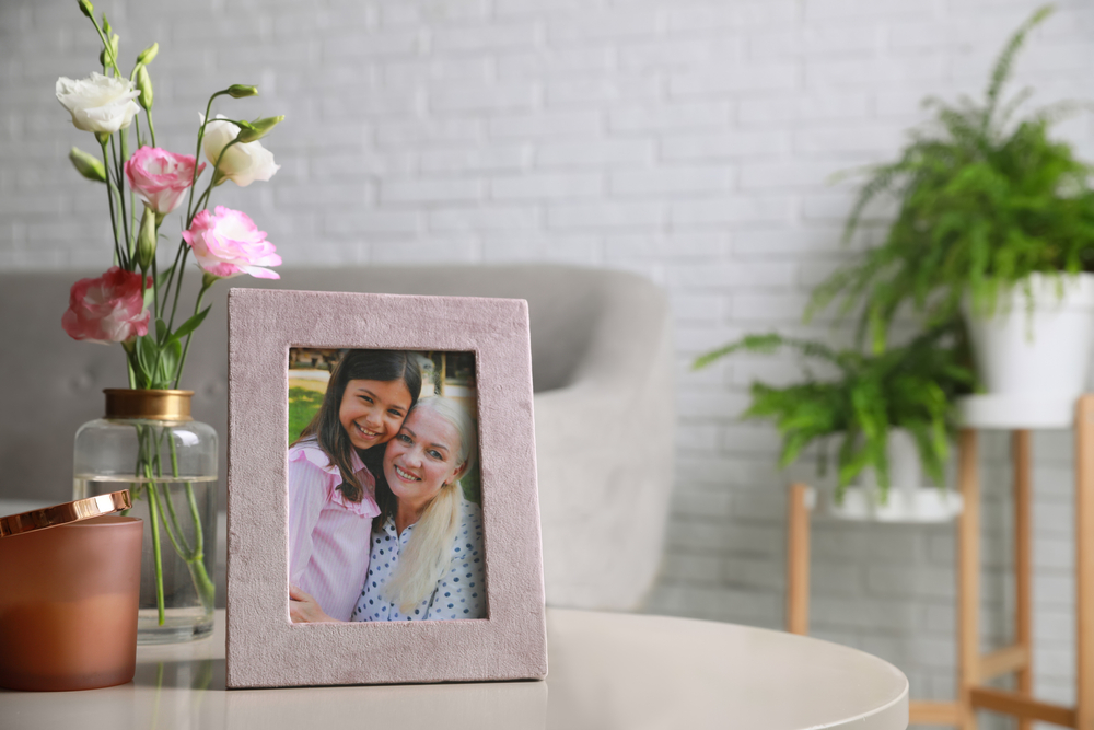 Framed family photo on light table in living room